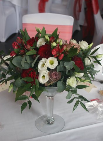 Short martini glass vase with Grand Prix and Amnesia roses, white lisianthus, Granada alstromeria and eucalyptus