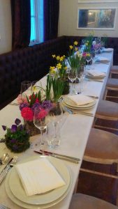 Springtime table with Tete-a-Tete narcissi, violas, hyacinths